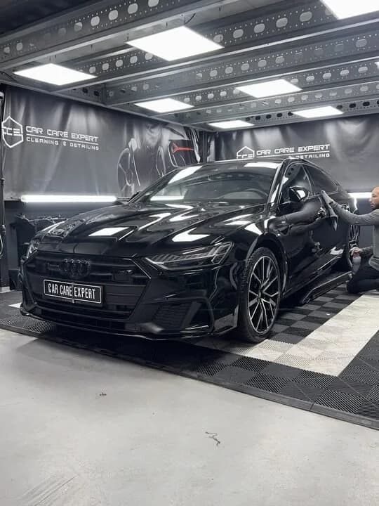 Ontvetten van de zwarte lak van een Audi S7 met een doek
